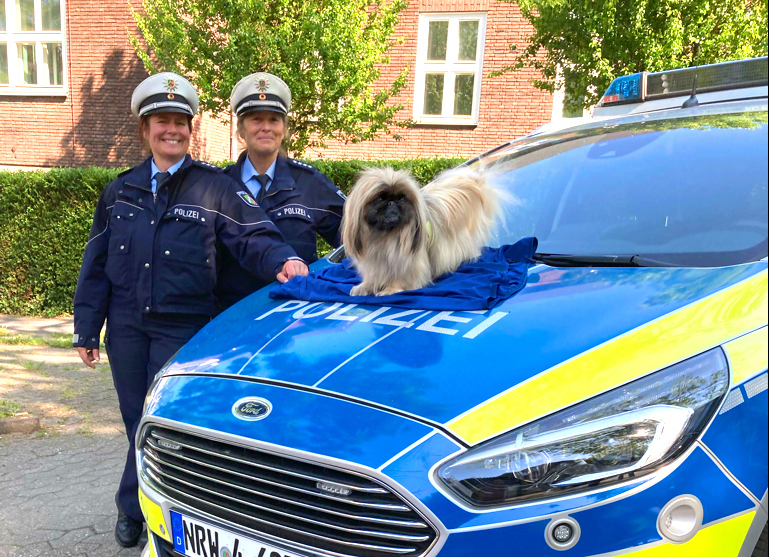 zwei Polizeibeamtinnen und ein Hund